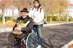 man on wheelchair with his assitant